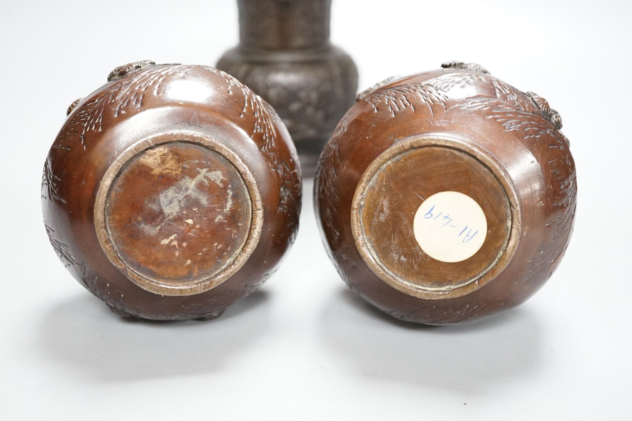 A pair of Japanese Meiji period bronze ‘dragon’ bottle vases and another, 21cm